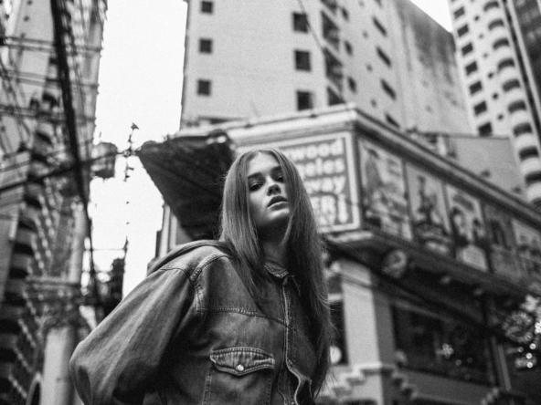 a black and white photo of a woman in a city