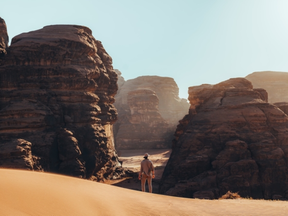 a man standing in the middle of a desert