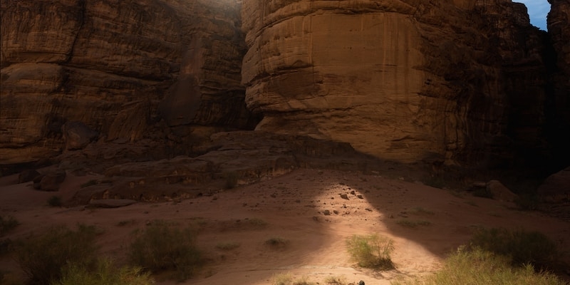 a man standing next to a tent in the desert